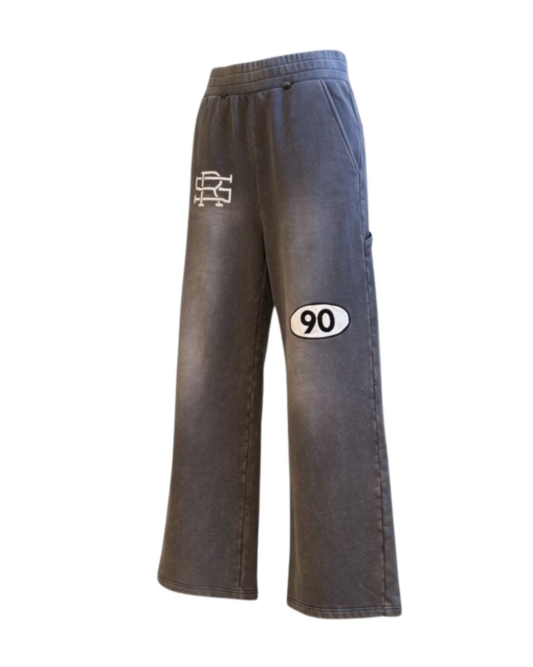 Product shot of Grey 90 Sweatpants with SMALL AND RARE insignia on the top right thigh and "90" patch on the left mid-thigh from the side left angle.