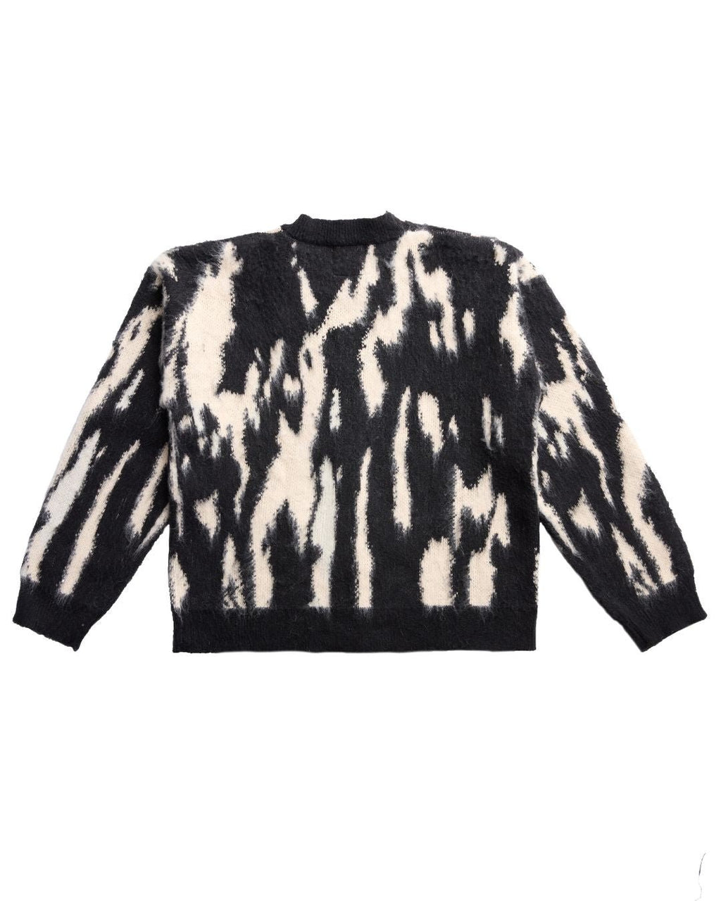 Close-up of the J Cardigan’s textured knit fabric highlighting soft, smooth surface and subtle stitch details from a