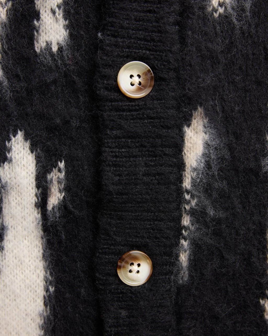 Close-up of the J Cardigan's textured knit fabric revealing subtle ribbing and cozy, lightweight feel perfect for layering.