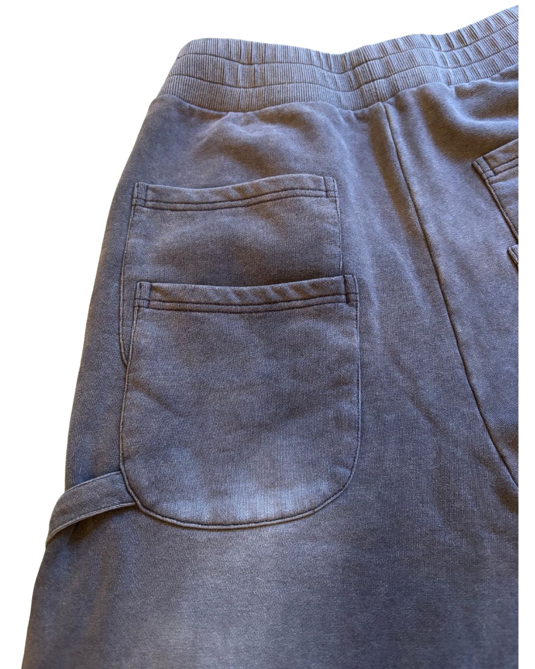 Close-up of the grey cotton-blend fabric highlighting the soft, textured surface and subtle seam detailing on the sweatpants.