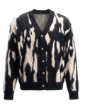 Product shot of J cardigan with Black and white pattern with button details on a white background.