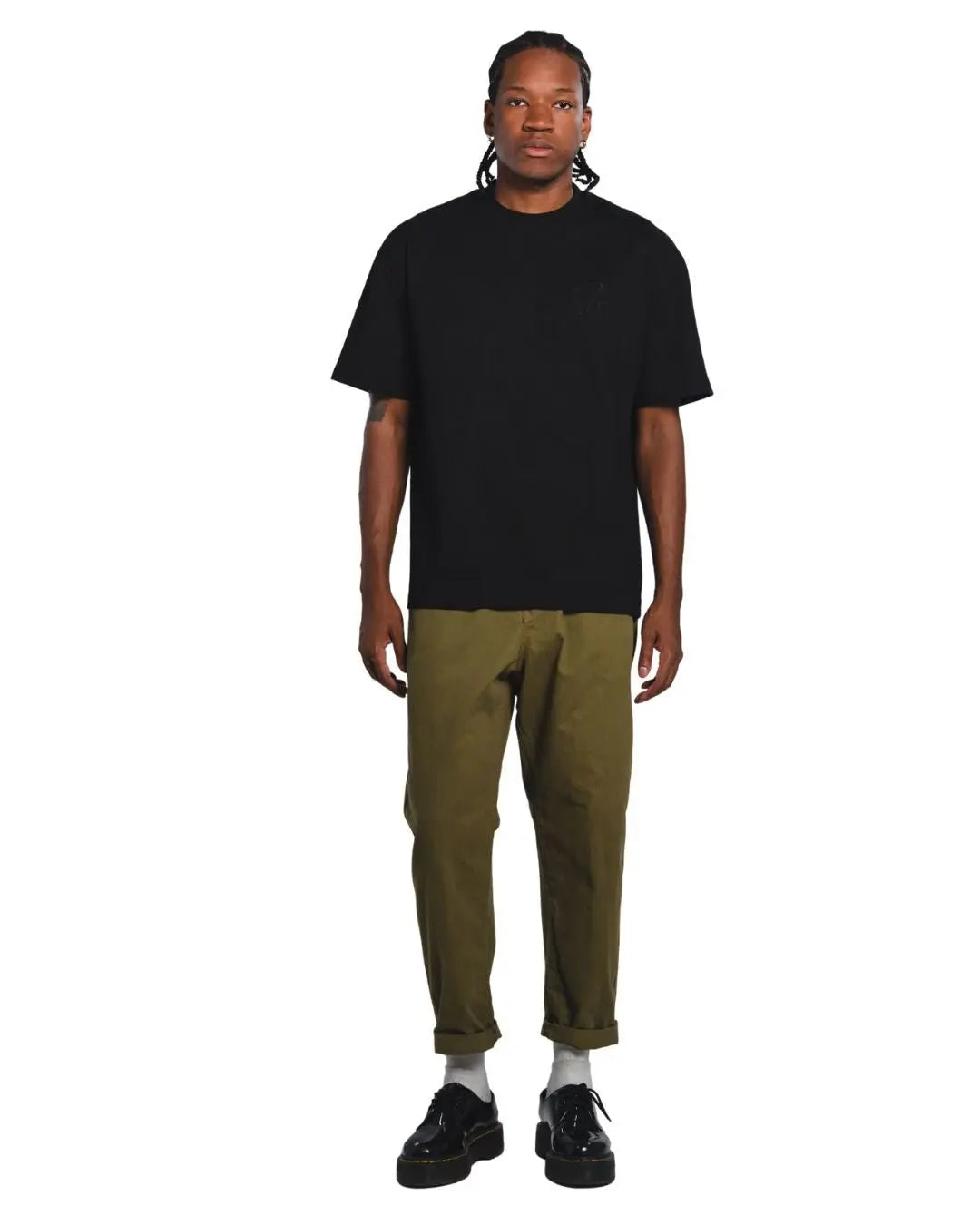 Male model wearing the Black Core Street Wear shirt featuring black embroidered insignia on left chest.
