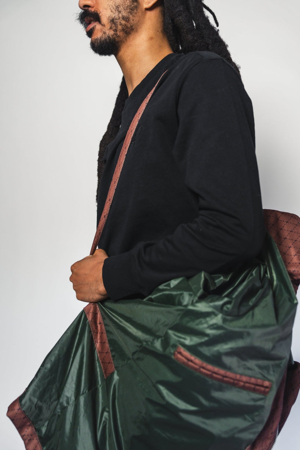 Close-up of the Versa Workwear Jacket’s navy cotton twill fabric and reinforced double-stitched hem detail at the waist.