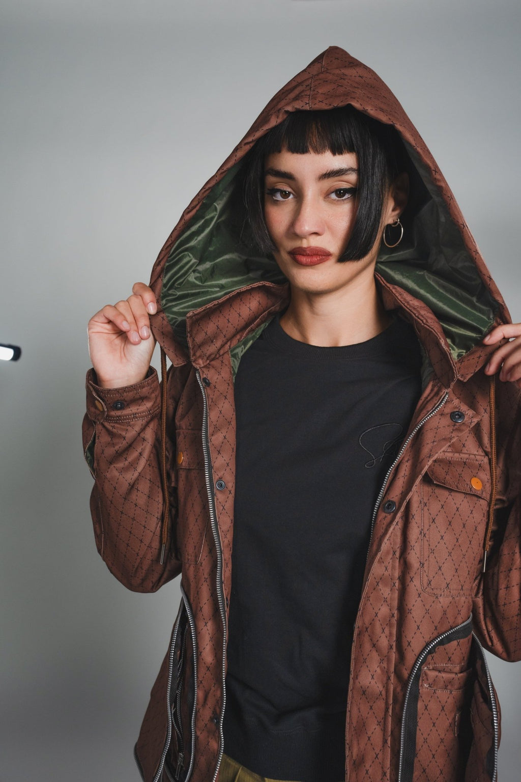 Close-up of Versa Workwear Jacket’s black nylon fabric with subtle texture and visible stitch detailing at the collar seam.