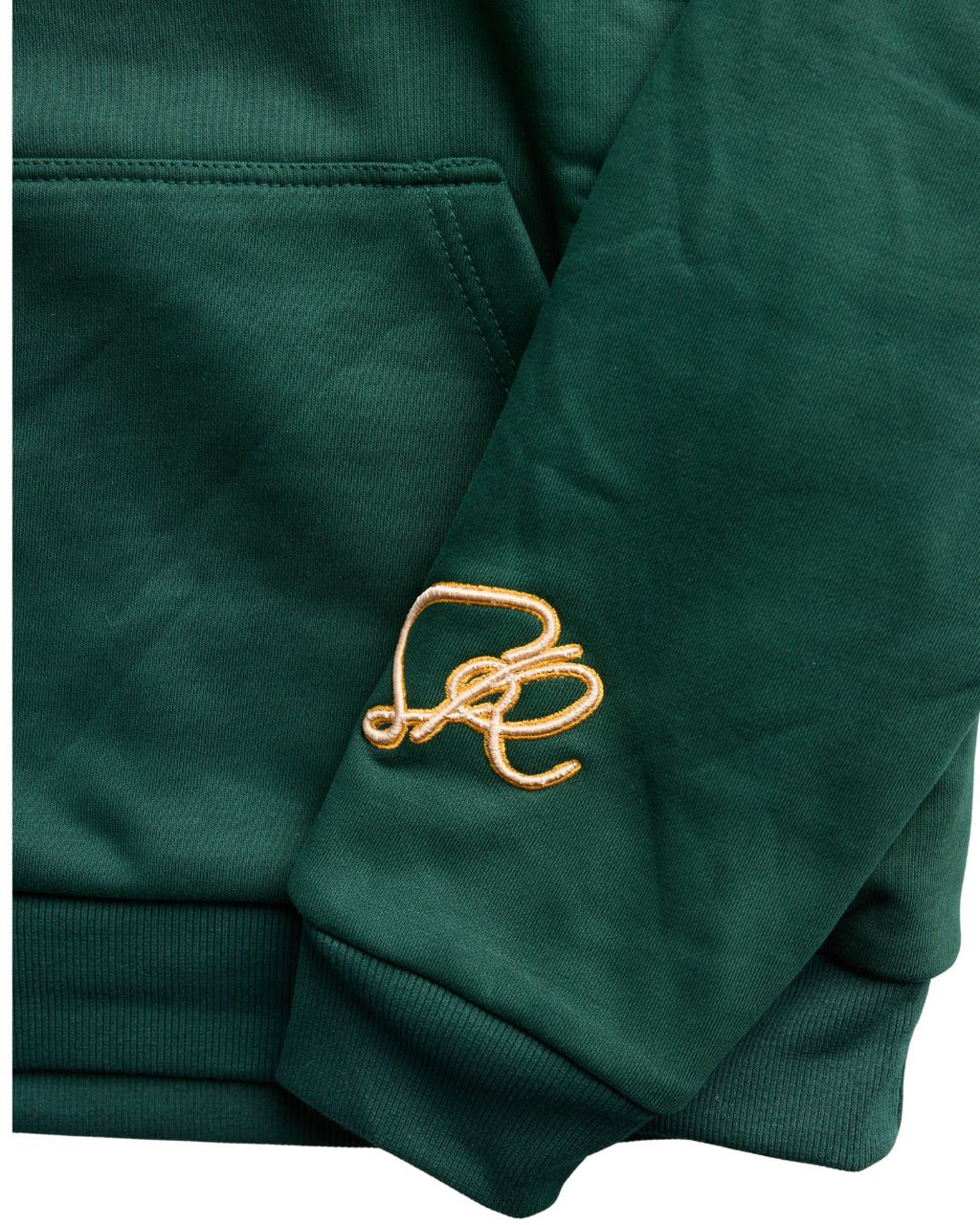 Close up of the Pine Reversable hoodie featuring embroidery on left wrist and kangaroo pockets.