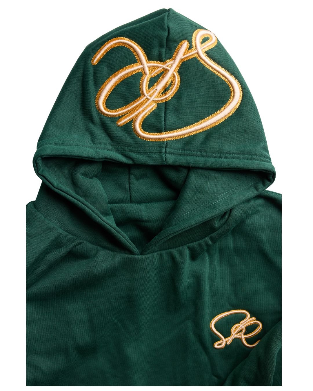 Close-up product shot of Pine Reversable hoodie with golden embroidered insignia's on the hood and left chest.