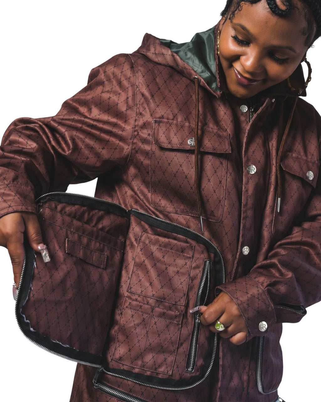 Product shot of woman wearing Versa Workwear Jacket showing off butterfly pockets and delicate textile pattern.