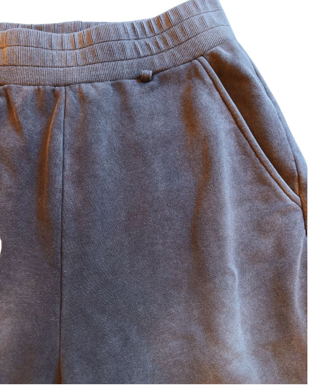 Close-up of grey cotton-blend fabric highlighting subtle heather pattern and relaxed fit waistband detail.