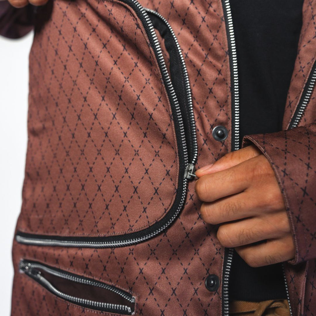Close-up of the Versa Workwear Jacket's textured recycled polyester fabric highlighting the subtle diamond pattern and
