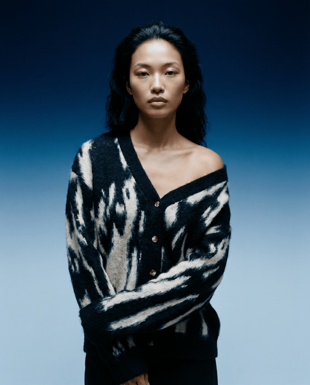 Close-up of the J Cardigan's textured knit fabric highlighting intricate stitching and soft, cozy feel under natural lighting